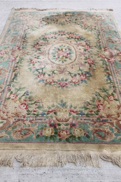 A WONDERFUL ANTIQUE PURE WOOL PILE CARPET (2.9m x 1.8m) WITH GREENS, PINKS, TANS AND EARTHY TONES