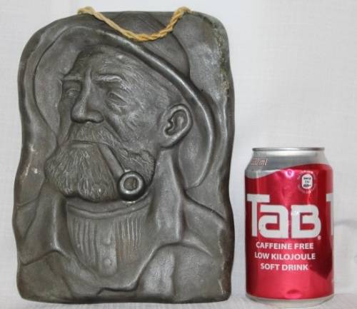 A RARE ANTIQUE HAMMERED WALL HANGING PEWTER TILE OF DORUS RIJKERS THE ''PIPE-SMOKING FISHERMAN''
