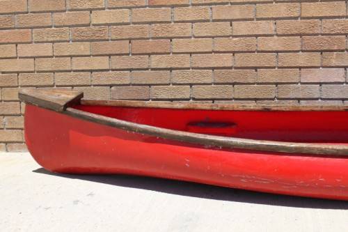 An incredible bright red rowing boat with a wooden oar in excellent condition | RS17
