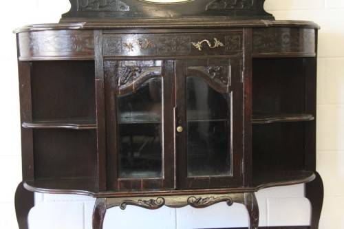 A magnificent display cabinet with a beveled mirror, cupboards and loads of shelf space