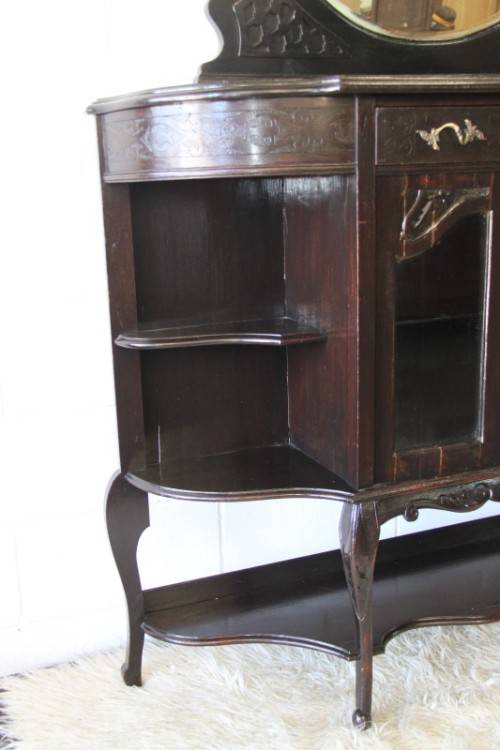A magnificent display cabinet with a beveled mirror, cupboards and loads of shelf space