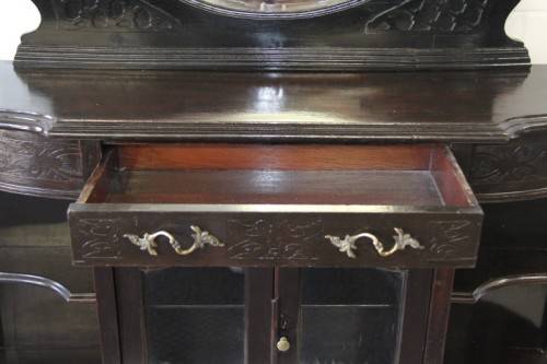 A magnificent display cabinet with a beveled mirror, cupboards and loads of shelf space