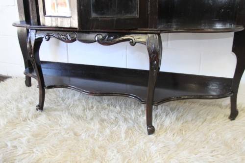 A magnificent display cabinet with a beveled mirror, cupboards and loads of shelf space