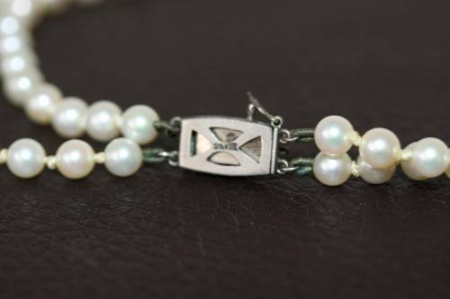 A spectacular double-strand pearl necklace with a sterling silver engraved clasp & pearl earrings