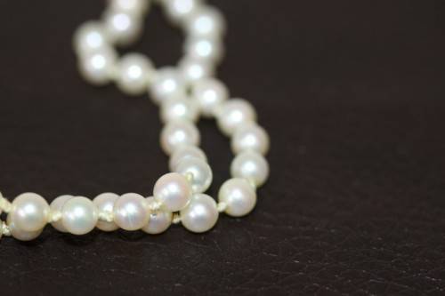 A spectacular double-strand pearl necklace with a sterling silver engraved clasp & pearl earrings