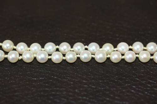 A spectacular double-strand pearl necklace with a sterling silver engraved clasp & pearl earrings