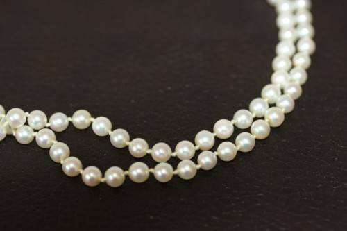 A spectacular double-strand pearl necklace with a sterling silver engraved clasp & pearl earrings