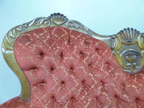A spectacular hand carved Victorian couch with deep button detailing and rolled padded armrests!