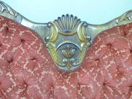 A spectacular hand carved Victorian couch with deep button detailing and rolled padded armrests!