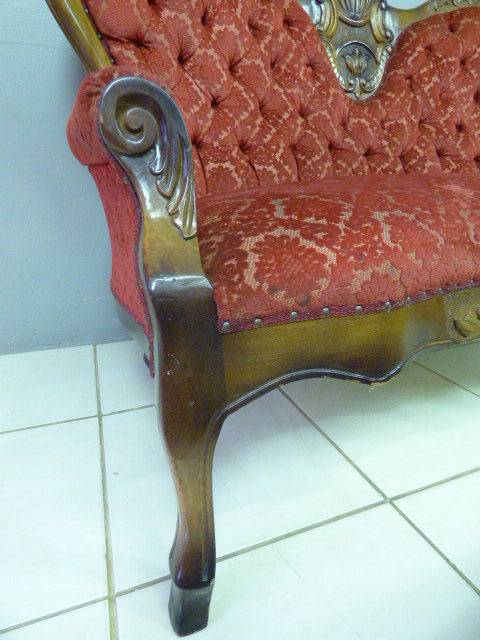 A spectacular hand carved Victorian couch with deep button detailing and rolled padded armrests!