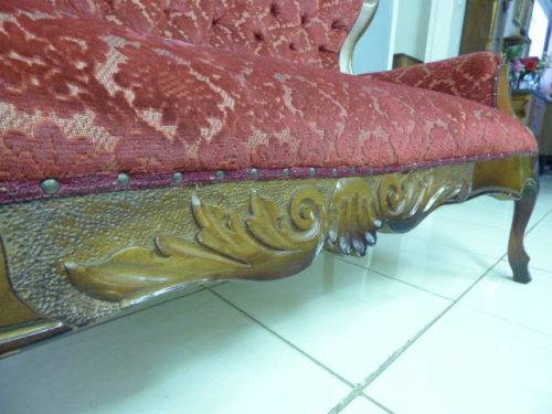 A spectacular hand carved Victorian couch with deep button detailing and rolled padded armrests!