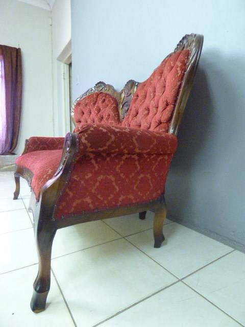 A spectacular hand carved Victorian couch with deep button detailing and rolled padded armrests!