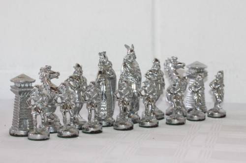 An amazing vintage/ antique? cast iron "Viking" silver & gold plated chess set in its original box