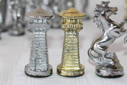 An amazing vintage/ antique? cast iron "Viking" silver & gold plated chess set in its original box