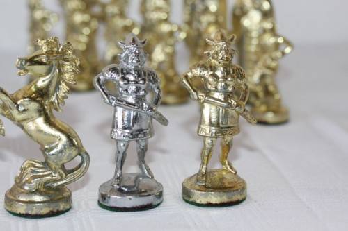 An amazing vintage/ antique? cast iron "Viking" silver & gold plated chess set in its original box