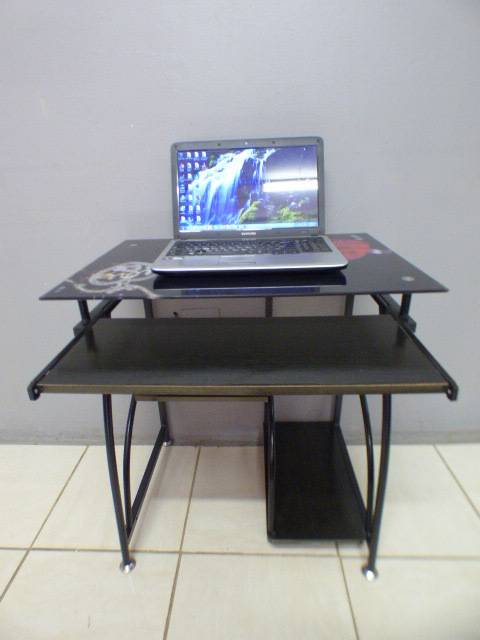 A lovely glass top writing/computer desk in good condition. Lovely in a ladies room.