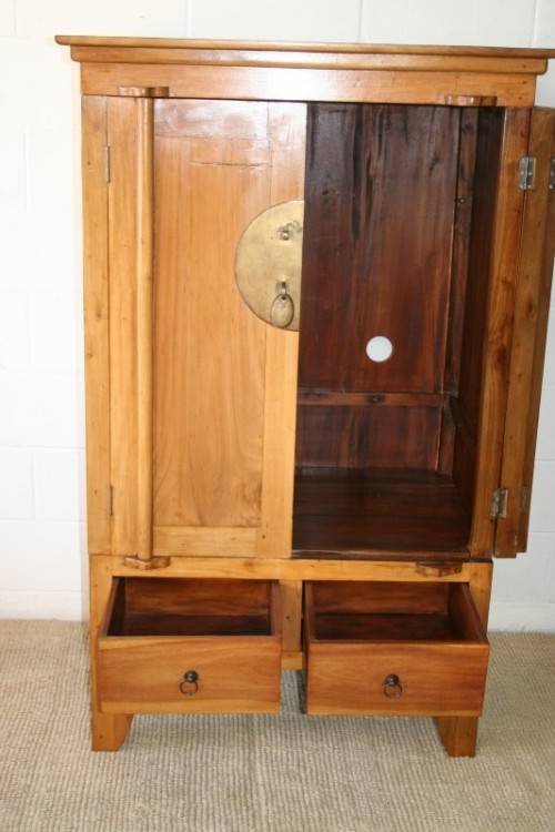 A magnificent Indonesian teak entertainment cabinet with traditional solid brass embellishments