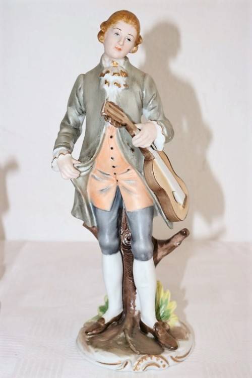 Three wonderful ceramic figurines of men with musical instruments with hand painted detailing