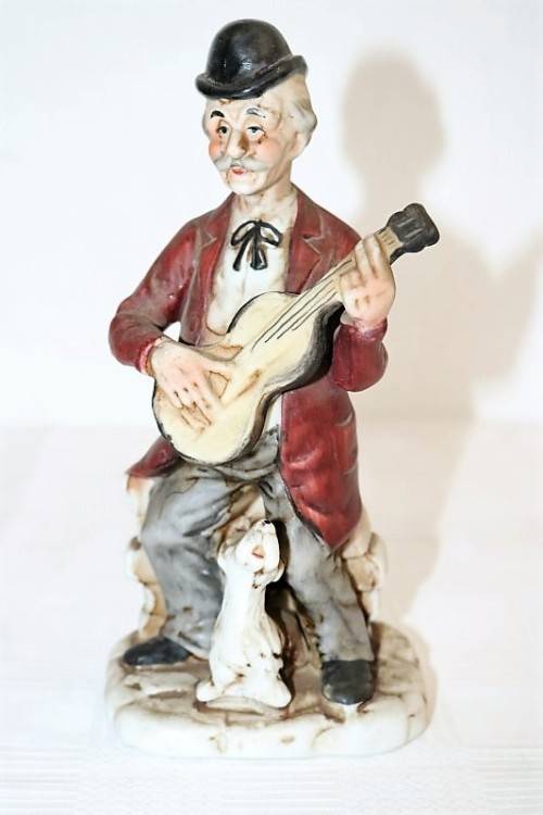 Three wonderful ceramic figurines of men with musical instruments with hand painted detailing
