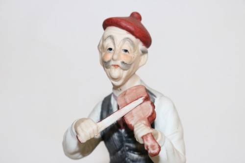 Three wonderful ceramic figurines of men with musical instruments with hand painted detailing