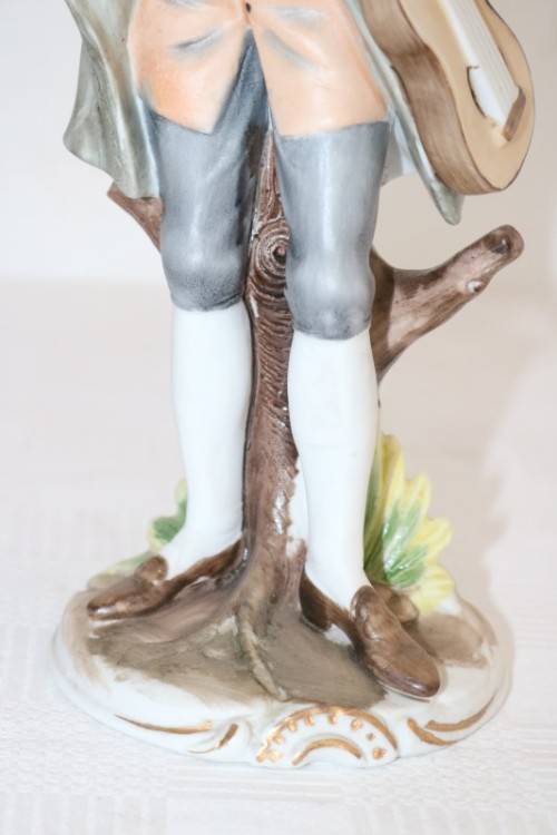 Three wonderful ceramic figurines of men with musical instruments with hand painted detailing