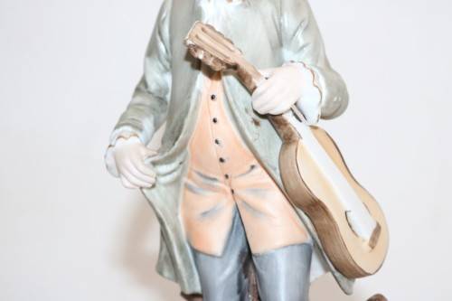 Three wonderful ceramic figurines of men with musical instruments with hand painted detailing