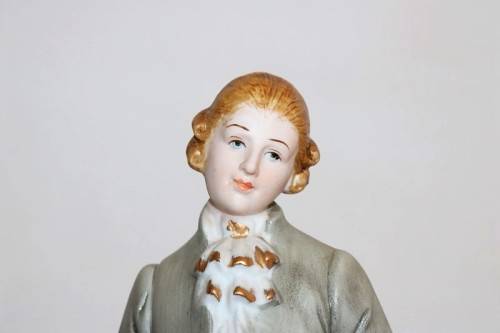 Three wonderful ceramic figurines of men with musical instruments with hand painted detailing