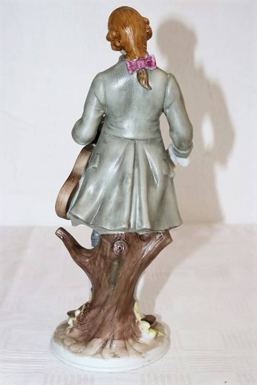 Three wonderful ceramic figurines of men with musical instruments with hand painted detailing