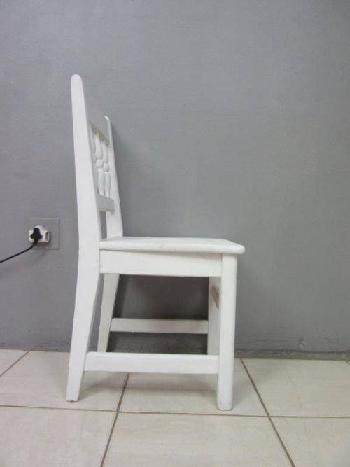 A solid wooden white dining in good condition - perfect for a beach house!