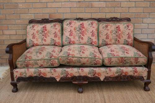 A wonderful antique hand carved ball and claw three-seater wicker-back sofa w/ upholstered cushions