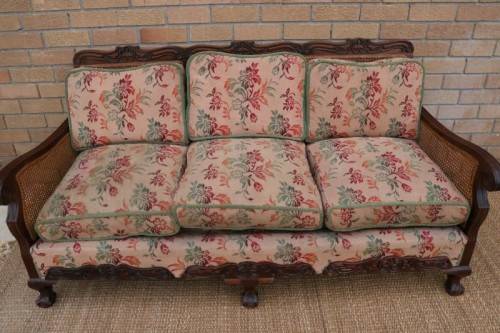 A wonderful antique hand carved ball and claw three-seater wicker-back sofa w/ upholstered cushions