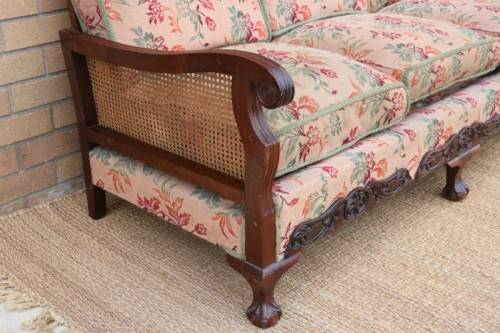 A wonderful antique hand carved ball and claw three-seater wicker-back sofa w/ upholstered cushions