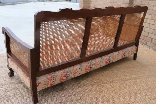 A wonderful antique hand carved ball and claw three-seater wicker-back sofa w/ upholstered cushions