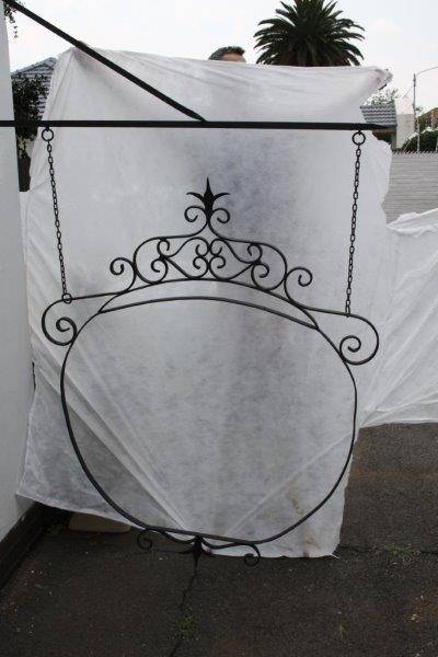 An awesome large wrought iron "Barney's Pub, Gold Reef City" signage wall frame with the bracket