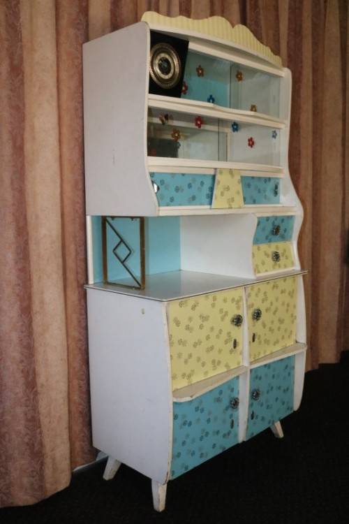 A fantastic Art Deco Hoosier kitchen cabinet w/ loads of cupboard space & a built in clock
