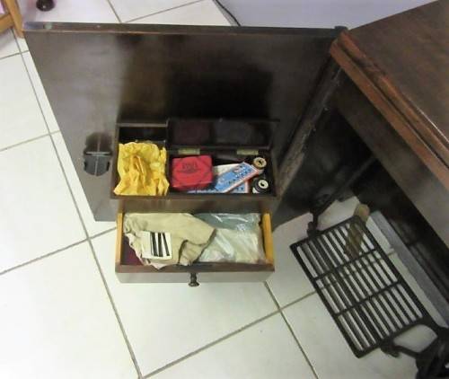 An incredible vintage (1930) singer "treadle" sewing machine in its cabinet in wonderful condition