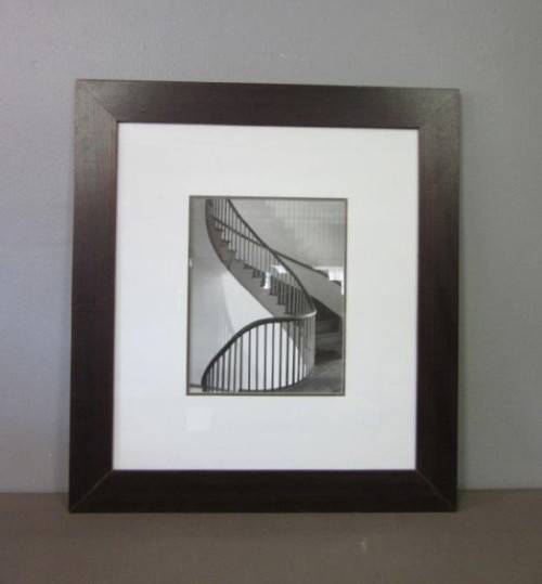 **RS17** A (large) black and white photograph of a spiral staircase in a broad-border frame