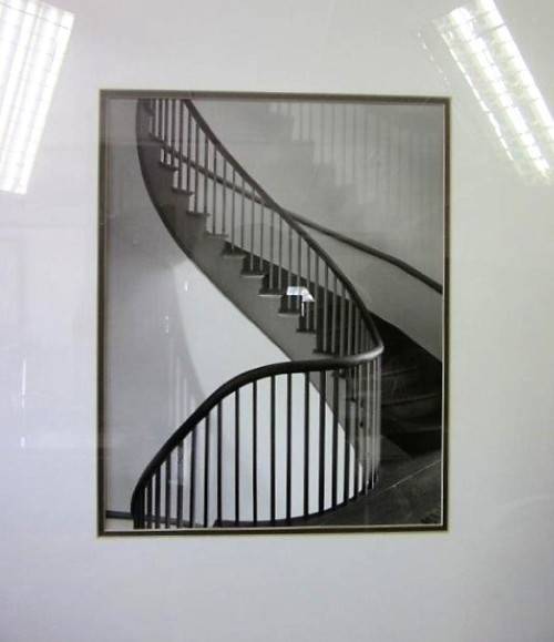 **RS17** A (large) black and white photograph of a spiral staircase in a broad-border frame