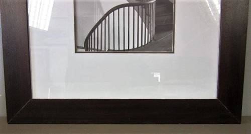 **RS17** A (large) black and white photograph of a spiral staircase in a broad-border frame