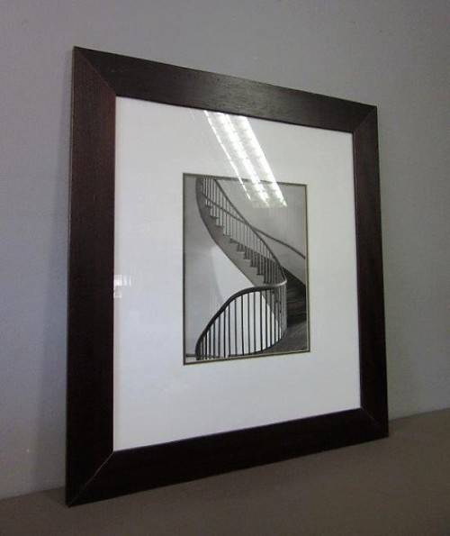 **RS17** A (large) black and white photograph of a spiral staircase in a broad-border frame