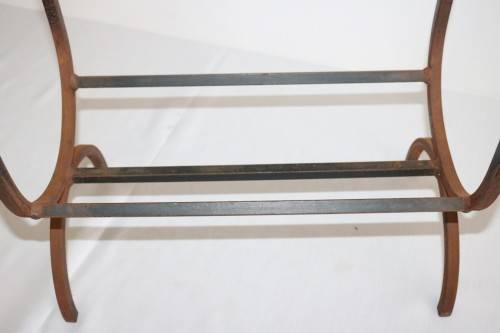 An awesome and well made wrought iron fireplace log holder with stunning "arrow" finials