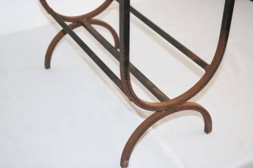 An awesome and well made wrought iron fireplace log holder with stunning "arrow" finials