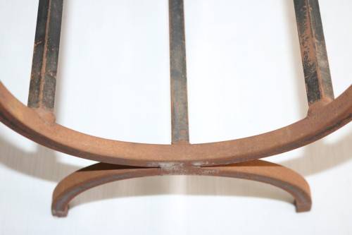 An awesome and well made wrought iron fireplace log holder with stunning "arrow" finials