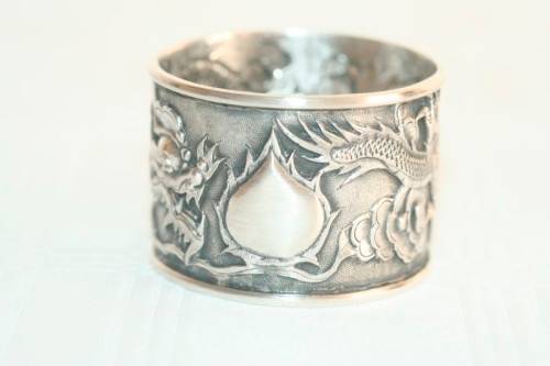 An incredible and rare Chinese solid silver "Dragon" napkin ring with amazing hand chased detailing