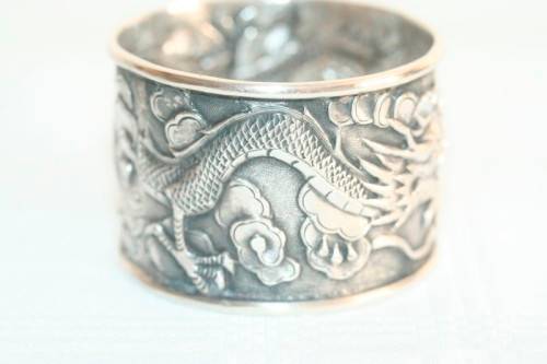 An incredible and rare Chinese solid silver "Dragon" napkin ring with amazing hand chased detailing
