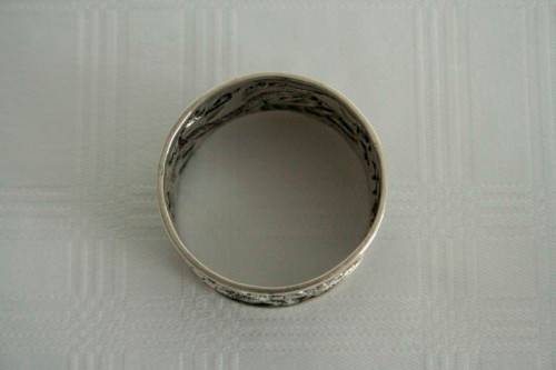 An incredible and rare Chinese solid silver "Dragon" napkin ring with amazing hand chased detailing