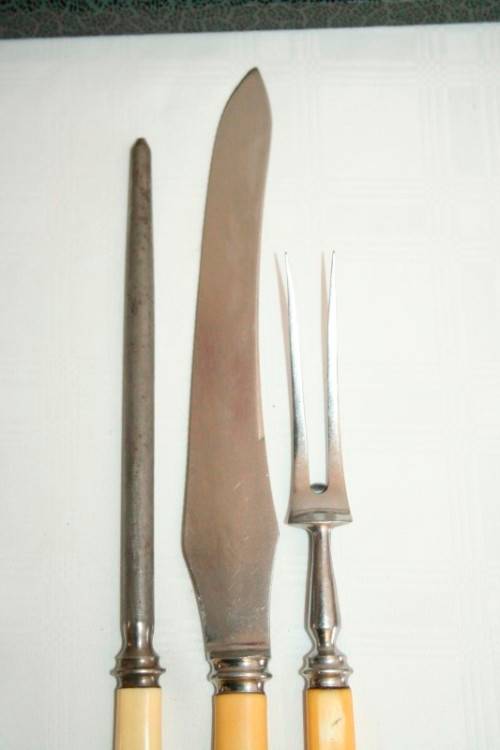 A stunning vintage boxed bone handle style carving knife and fork set with a sharpening steel