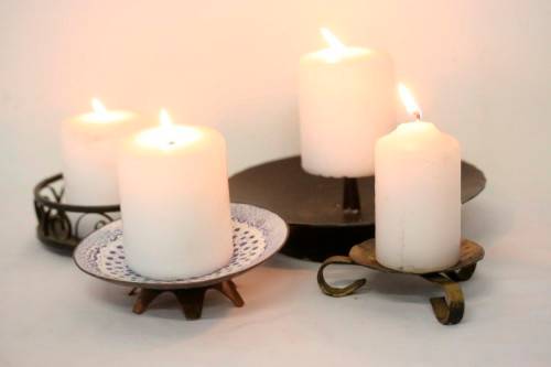 **RS17** Four lovely assorted metal candle holders, perfect in informal living areas.