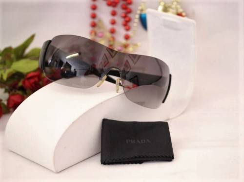 An awesome pair of black Italian made Prada (model SPR22M) ladies sunglasses w/ grey gradient lenses