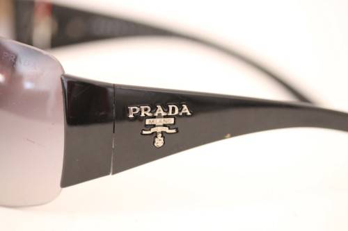 An awesome pair of black Italian made Prada (model SPR22M) ladies sunglasses w/ grey gradient lenses